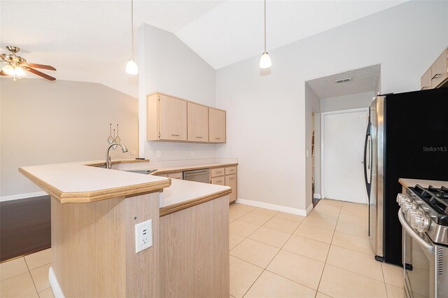 1115 Marni Ridge Ct, Kissimmee, FL 34747 - kitchen featuring light brown cabinetry, stainless steel appliances, lofted ceiling, ceiling fan, and a sink