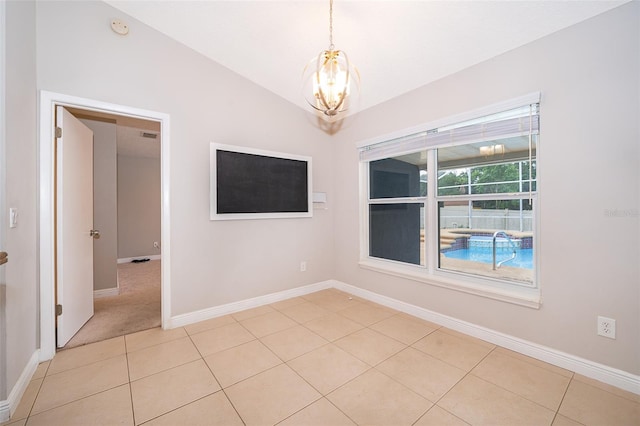 1115 Marni Ridge Ct, Kissimmee, FL 34747 - empty room featuring a chandelier, vaulted ceiling, light tile patterned floors, baseboards, and a smoke detector
