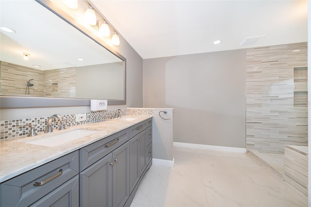 1115 Marni Ridge Ct, Kissimmee, FL 34747 - full bath featuring double vanity, a walk in shower, baseboards, marble finish flooring, and backsplash