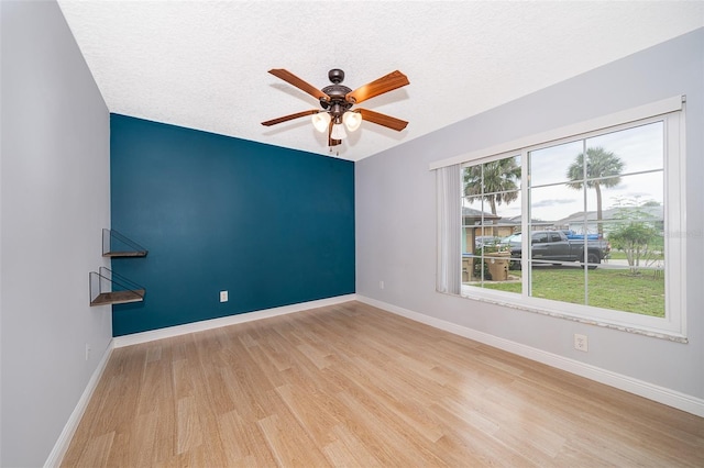 1115 Marni Ridge Ct, Kissimmee, FL 34747 - unfurnished room with ceiling fan, wood finished floors, baseboards, and a textured ceiling