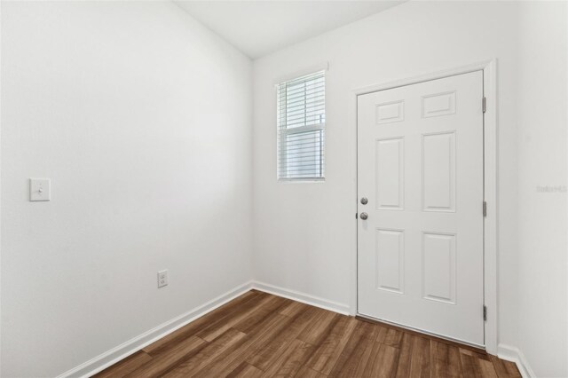 6178 Daerr Ridge St, Zephyrhills, FL 33542 - foyer entrance featuring dark wood-style floors and baseboards