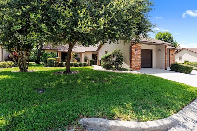 154 Golf Club Dr Unit 154, Longwood, FL 32779 - obstructed view of property with stucco siding, a front yard, an attached garage, and concrete driveway