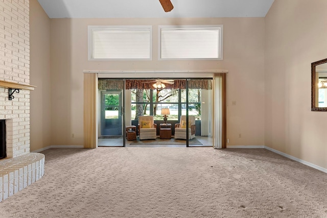 154 Golf Club Dr Unit 154, Longwood, FL 32779 - living room with a towering ceiling, carpet floors, ceiling fan, and a fireplace