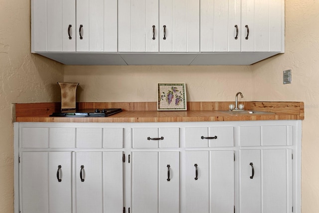 154 Golf Club Dr Unit 154, Longwood, FL 32779 - kitchen featuring white cabinetry, a textured wall, and light countertops