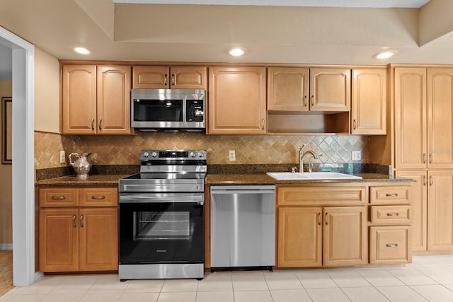 154 Golf Club Dr Unit 154, Longwood, FL 32779 - kitchen featuring stainless steel appliances, decorative backsplash, light brown cabinetry, dark stone countertops, and light tile patterned floors