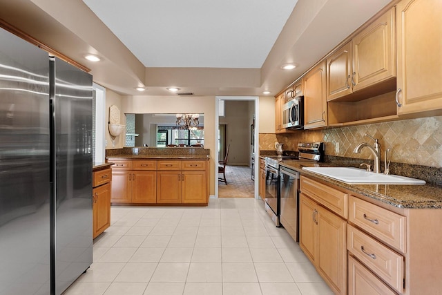 154 Golf Club Dr Unit 154, Longwood, FL 32779 - kitchen with appliances with stainless steel finishes, light tile patterned floors, decorative backsplash, recessed lighting, and a chandelier