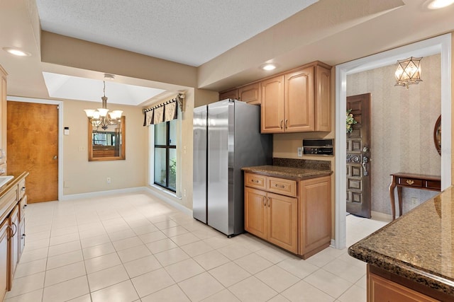 154 Golf Club Dr Unit 154, Longwood, FL 32779 - kitchen with freestanding refrigerator, a chandelier, decorative light fixtures, a textured ceiling, and dark stone counters