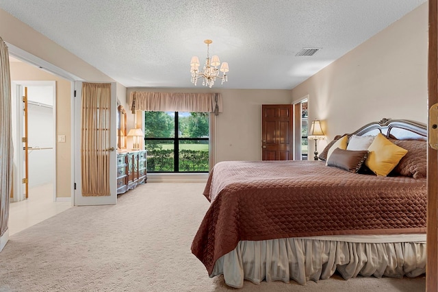 154 Golf Club Dr Unit 154, Longwood, FL 32779 - bedroom with carpet floors, a chandelier, and a textured ceiling