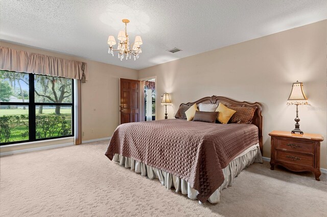 154 Golf Club Dr Unit 154, Longwood, FL 32779 - bedroom featuring a chandelier, light carpet, and a textured ceiling