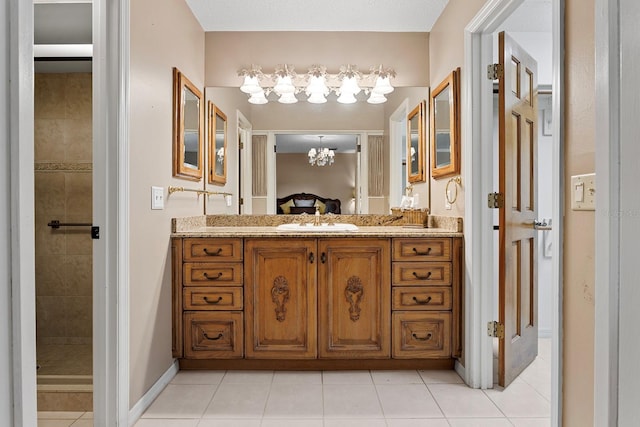 154 Golf Club Dr Unit 154, Longwood, FL 32779 - ensuite bathroom featuring a chandelier, vanity, tile patterned flooring, and tiled shower