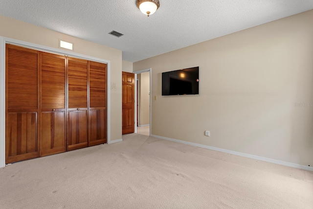154 Golf Club Dr Unit 154, Longwood, FL 32779 - unfurnished bedroom with light colored carpet, a closet, and a textured ceiling