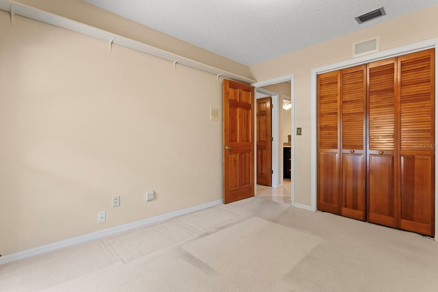 154 Golf Club Dr Unit 154, Longwood, FL 32779 - unfurnished bedroom featuring a closet, light carpet, and a textured ceiling