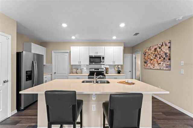 3430 Briarwood Grove Dr, Ocoee, FL 34761 - kitchen with stainless steel appliances, a breakfast bar area, dark wood-style flooring, recessed lighting, and tasteful backsplash