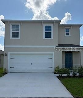 3430 Briarwood Grove Dr, Ocoee, FL 34761 - view of front of house with an attached garage, stucco siding, and driveway