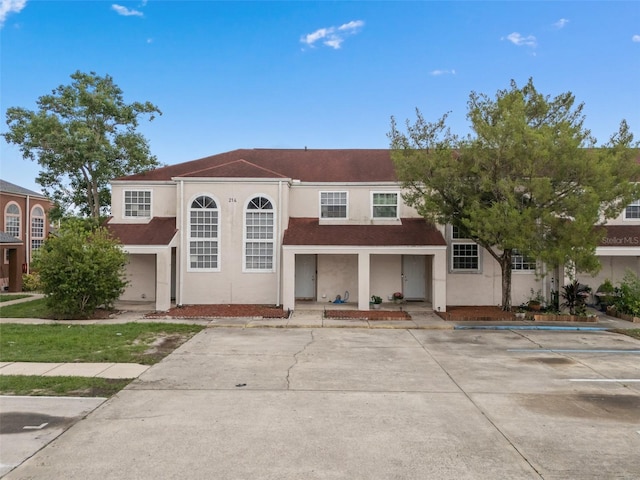 214 Majors Ln Unit B, Kissimmee, FL 34743 - view of front of property with stucco siding, uncovered parking, and covered porch