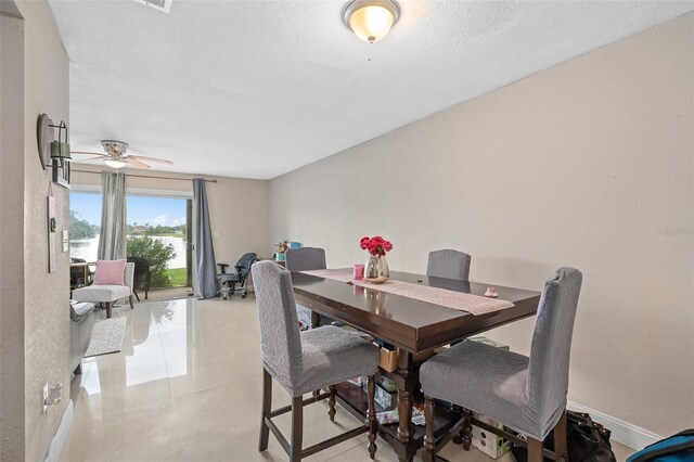 214 Majors Ln Unit B, Kissimmee, FL 34743 - dining space featuring ceiling fan, a water view, and light tile patterned flooring
