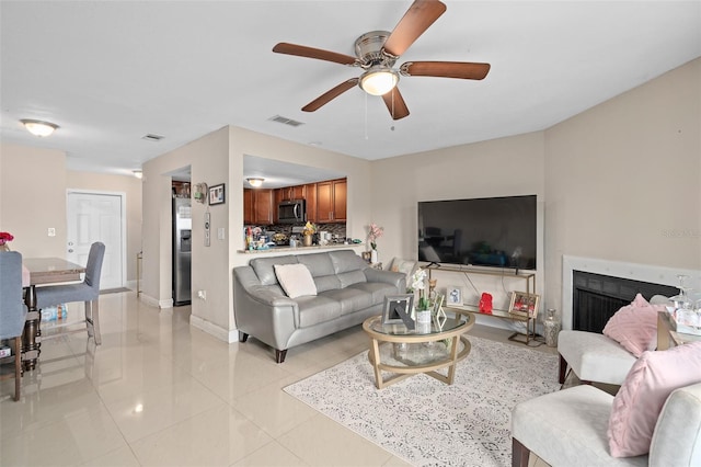 214 Majors Ln Unit B, Kissimmee, FL 34743 - living room featuring light tile patterned flooring, a ceiling fan, and baseboards
