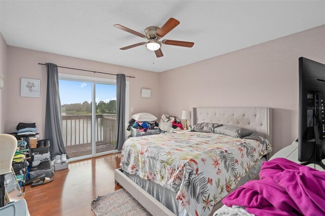 214 Majors Ln Unit B, Kissimmee, FL 34743 - bedroom featuring access to exterior, wood finished floors, ceiling fan, and a water view