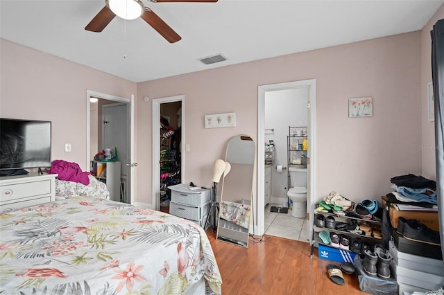 214 Majors Ln Unit B, Kissimmee, FL 34743 - bedroom with light wood-style floors, connected bathroom, and a ceiling fan