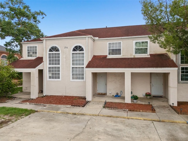 214 Majors Ln Unit B, Kissimmee, FL 34743 - view of property with stucco siding, a porch, and a shingled roof