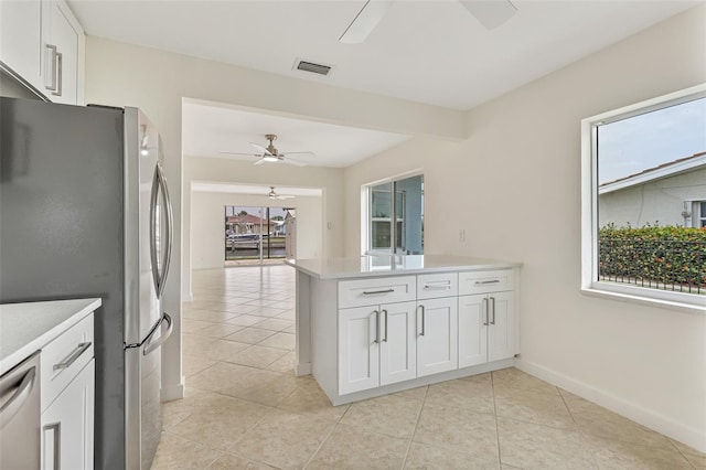 1764 Boca Raton Ct, Punta Gorda, FL 33950 - kitchen featuring a ceiling fan, stainless steel appliances, a peninsula, light countertops, and light tile patterned floors