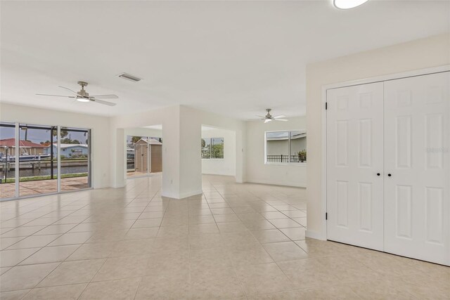 1764 Boca Raton Ct, Punta Gorda, FL 33950 - unfurnished living room with ceiling fan, light tile patterned flooring, and baseboards