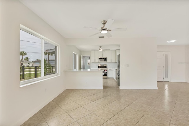 1764 Boca Raton Ct, Punta Gorda, FL 33950 - unfurnished living room with light tile patterned floors, a ceiling fan, and baseboards