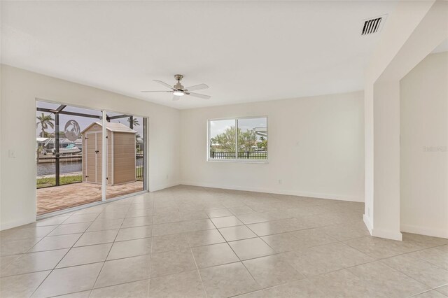 1764 Boca Raton Ct, Punta Gorda, FL 33950 - empty room featuring plenty of natural light, a ceiling fan, and light tile patterned flooring