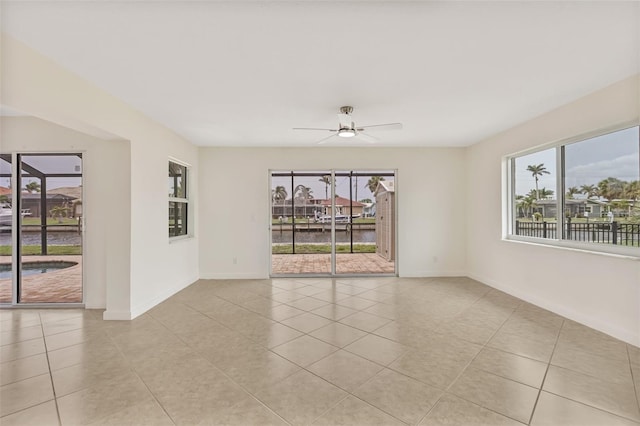 1764 Boca Raton Ct, Punta Gorda, FL 33950 - tiled spare room with plenty of natural light, baseboards, and a ceiling fan
