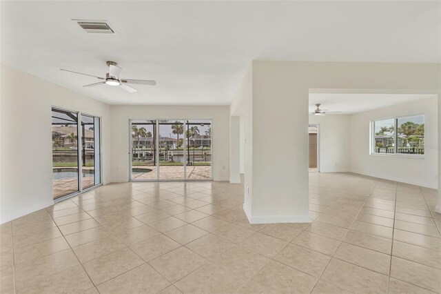 1764 Boca Raton Ct, Punta Gorda, FL 33950 - empty room with ceiling fan, light tile patterned floors, and healthy amount of natural light