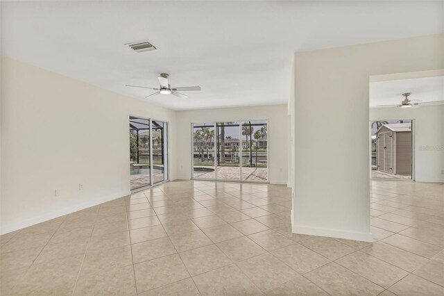 1764 Boca Raton Ct, Punta Gorda, FL 33950 - empty room with ceiling fan, light tile patterned floors, and baseboards