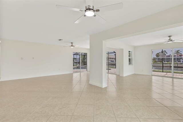1764 Boca Raton Ct, Punta Gorda, FL 33950 - spare room featuring light tile patterned floors, a ceiling fan, and baseboards