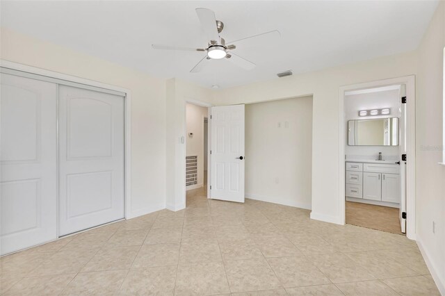 1764 Boca Raton Ct, Punta Gorda, FL 33950 - unfurnished bedroom with ensuite bathroom, light tile patterned floors, and baseboards