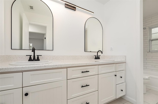 407 Ventura Dr, Sanford, FL 32773 - full bath featuring double vanity, toilet, tile patterned flooring, and bathing tub / shower combination