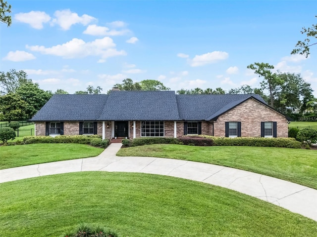 104 Amberwood Ct, Longwood, FL 32779 - ranch-style house with a front yard, brick siding, and a shingled roof