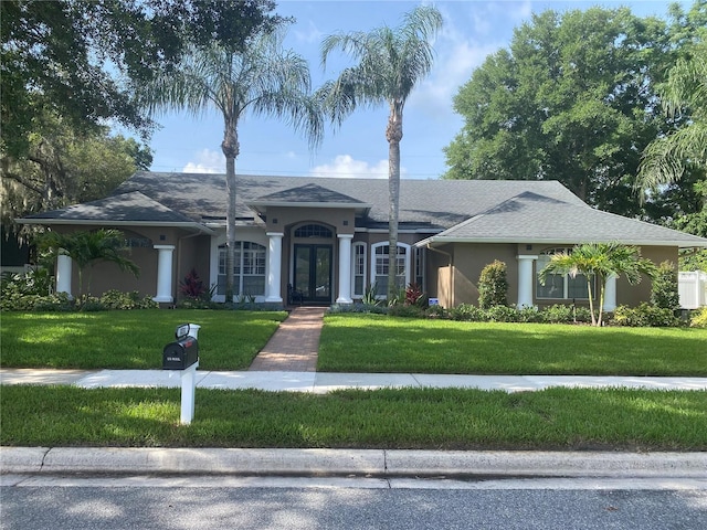 831 Royalwood Ln, Oviedo, FL 32765 - single story home with french doors, stucco siding, and a front yard