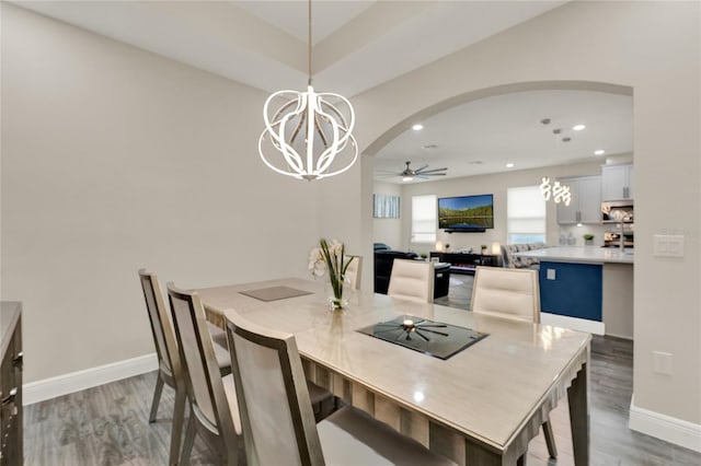 2390 Standing Rock Cir, Oakland, FL 34787 - dining room with wood finished floors, arched walkways, a ceiling fan, recessed lighting, and a chandelier