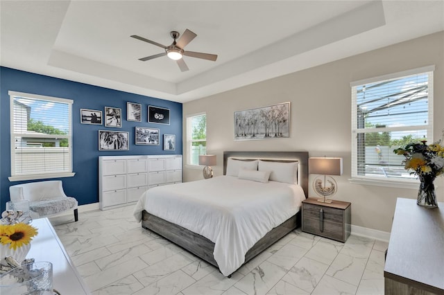 2390 Standing Rock Cir, Oakland, FL 34787 - bedroom featuring a tray ceiling, light marble finish flooring, and ceiling fan