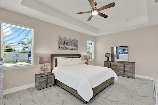 2390 Standing Rock Cir, Oakland, FL 34787 - bedroom featuring a tray ceiling, light marble finish flooring, and a ceiling fan