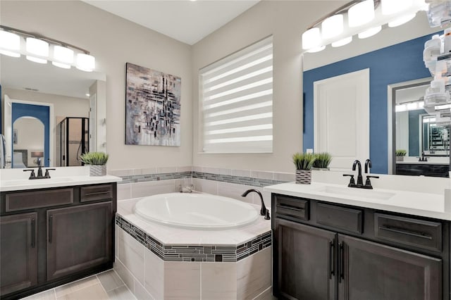 2390 Standing Rock Cir, Oakland, FL 34787 - full bathroom featuring a shower stall, two vanities, and a garden tub