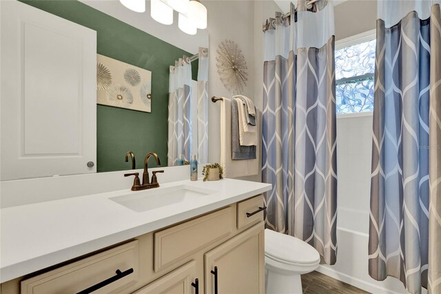 2390 Standing Rock Cir, Oakland, FL 34787 - bathroom featuring vanity, shower / bathtub combination with curtain, and wood finished floors