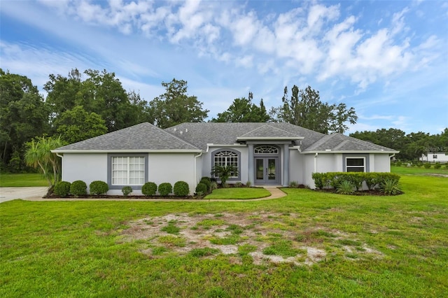 15038 Willow Ln, Tavares, FL 32778 - single story home featuring french doors, a front lawn, and stucco siding