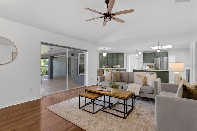 15038 Willow Ln, Tavares, FL 32778 - living area with a ceiling fan, wood finished floors, and vaulted ceiling