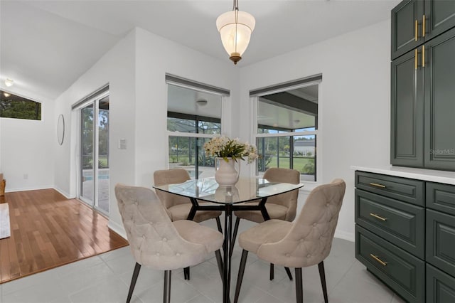 15038 Willow Ln, Tavares, FL 32778 - dining room featuring vaulted ceiling and light wood finished floors