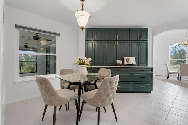 15038 Willow Ln, Tavares, FL 32778 - dining space with light tile patterned floors and a chandelier