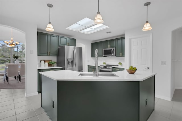15038 Willow Ln, Tavares, FL 32778 - kitchen featuring appliances with stainless steel finishes, a chandelier, arched walkways, light countertops, and light tile patterned flooring