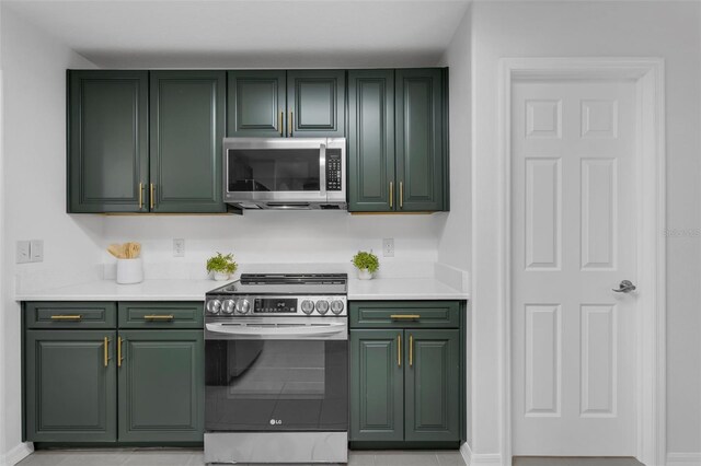 15038 Willow Ln, Tavares, FL 32778 - kitchen with green cabinets, appliances with stainless steel finishes, and light countertops