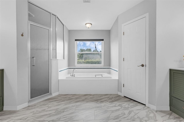 15038 Willow Ln, Tavares, FL 32778 - bathroom with marble look tiles, a garden tub, and a shower stall