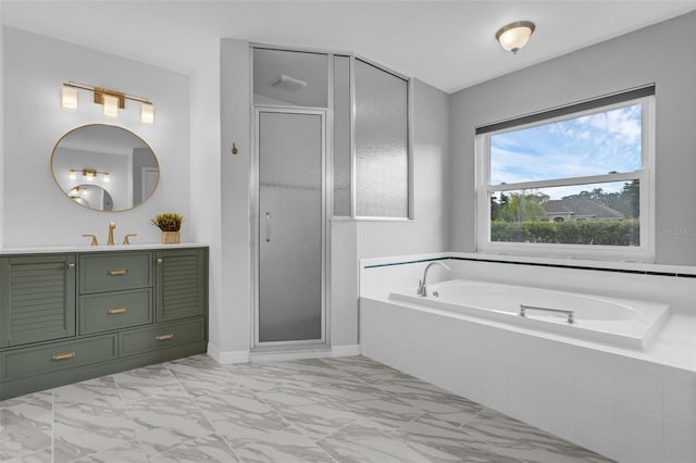 15038 Willow Ln, Tavares, FL 32778 - bathroom featuring marble finish flooring, vanity, a garden tub, and a shower stall