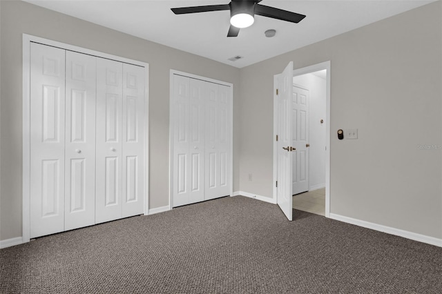 15038 Willow Ln, Tavares, FL 32778 - unfurnished bedroom featuring two closets, carpet flooring, and ceiling fan